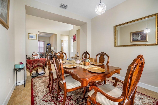 dining space featuring light tile patterned floors