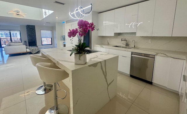 1127 Boca Cove Ln Unit 3, Highland Beach, FL 33487 - kitchen with dishwasher, a sink, modern cabinets, white cabinets, and light tile patterned floors