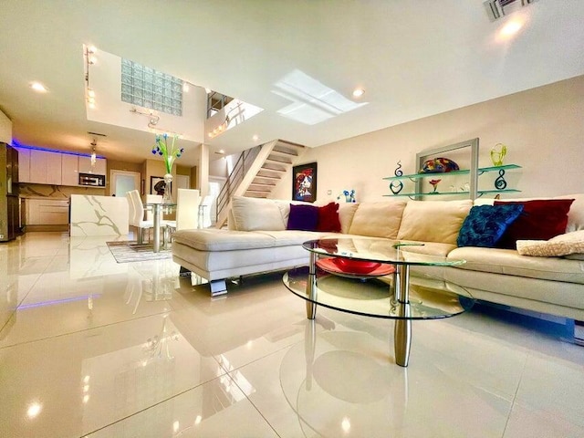 living area with stairway, visible vents, and recessed lighting