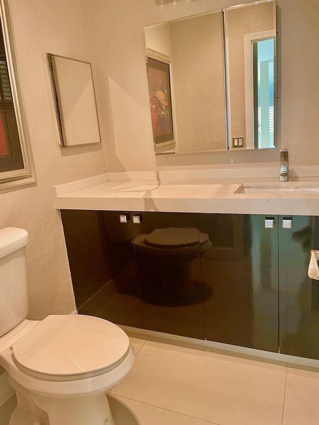 bathroom featuring vanity, toilet, and tile patterned floors