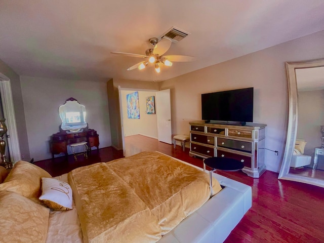 bedroom with a ceiling fan, visible vents, and wood finished floors