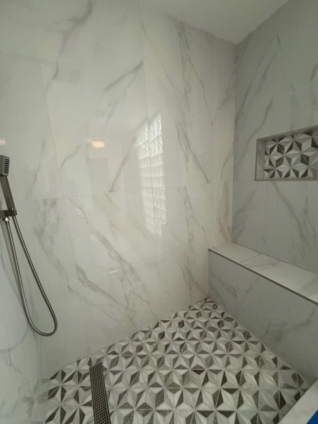 full bath with a marble finish shower