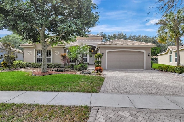 mediterranean / spanish-style house with a front yard and a garage