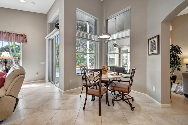 dining room with plenty of natural light, ceiling fan, and light tile patterned floors