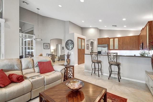 living room featuring high vaulted ceiling and light tile patterned flooring