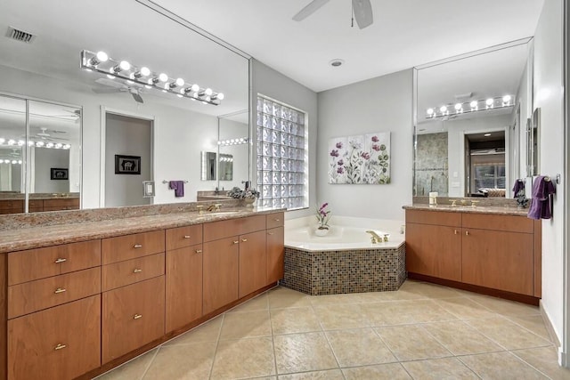 bathroom with tile patterned floors, ceiling fan, plenty of natural light, and vanity