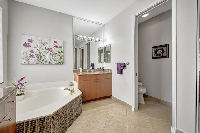 bathroom with tile patterned floors, vanity, tiled bath, and toilet