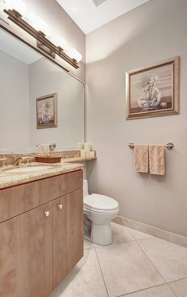 bathroom with tile patterned floors, vanity, and toilet