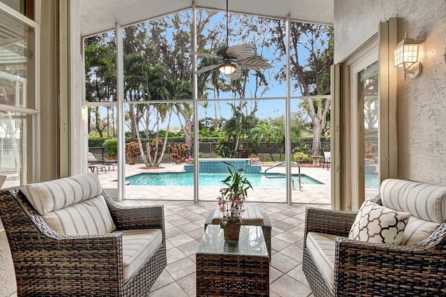 view of pool with glass enclosure and a patio