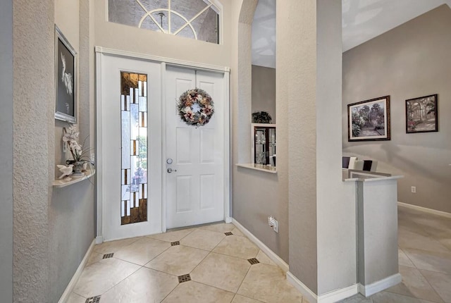 foyer entrance with light tile patterned flooring