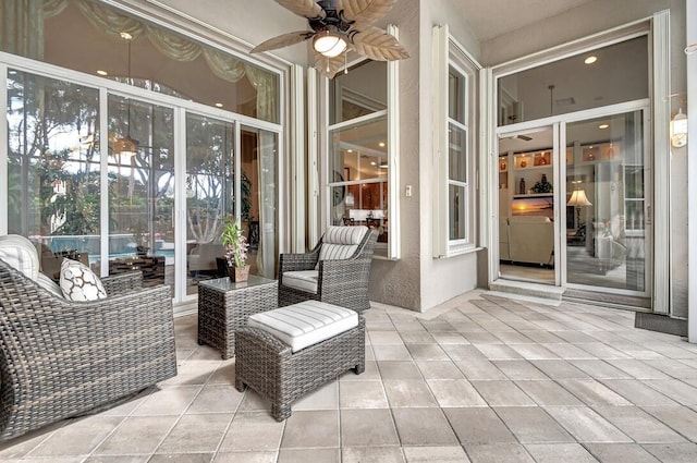 sunroom featuring ceiling fan