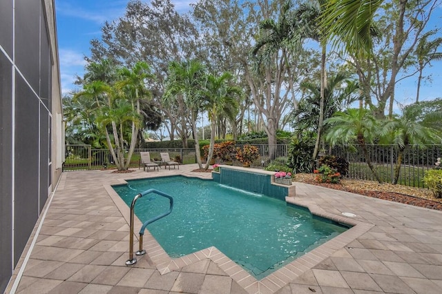 view of swimming pool with a patio area and pool water feature