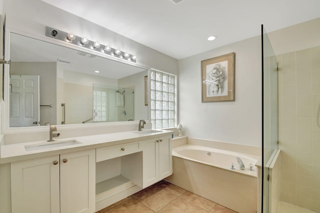 bathroom with tile patterned flooring, vanity, and independent shower and bath