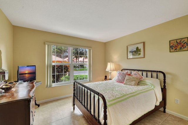 bedroom with light tile patterned floors