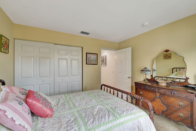 bedroom with a closet and light tile patterned floors