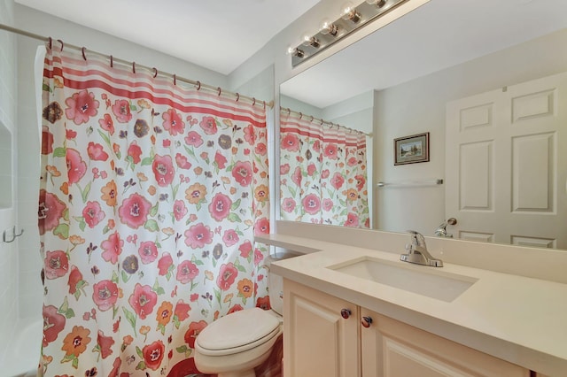 bathroom featuring a shower with shower curtain, vanity, and toilet