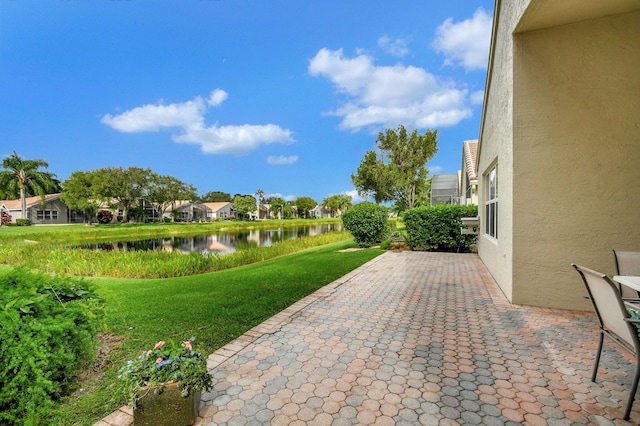 view of patio with a water view