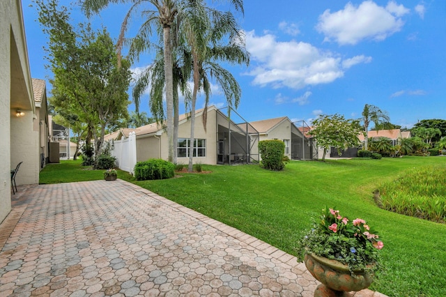 exterior space with glass enclosure and a front lawn