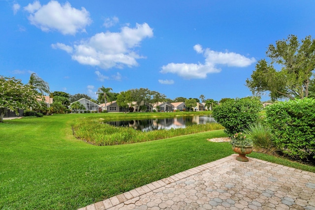 view of yard featuring a patio area and a water view