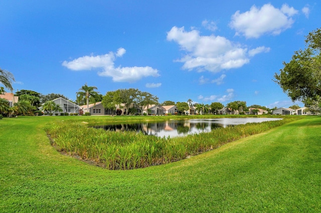 view of property's community with a yard and a water view