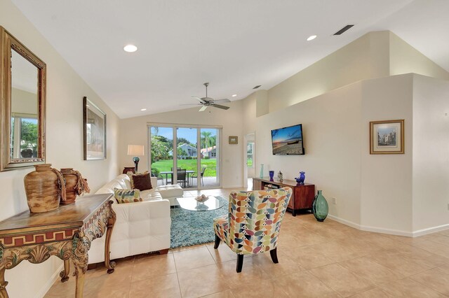 tiled living room featuring ceiling fan and vaulted ceiling