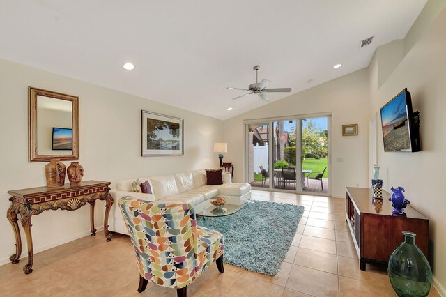 living room featuring ceiling fan, light tile patterned flooring, and lofted ceiling