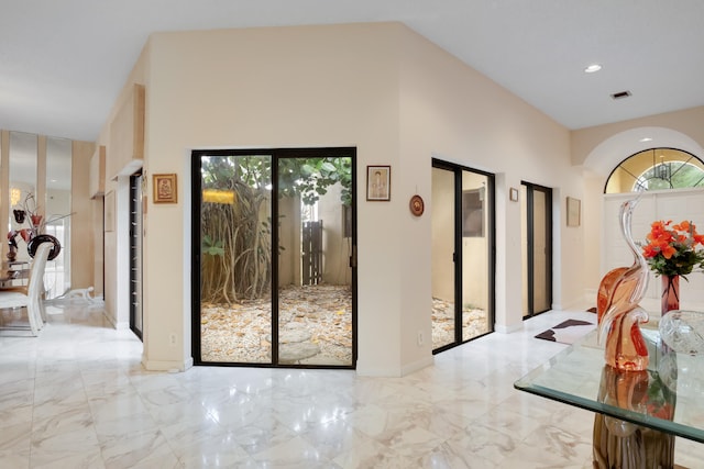 doorway featuring high vaulted ceiling