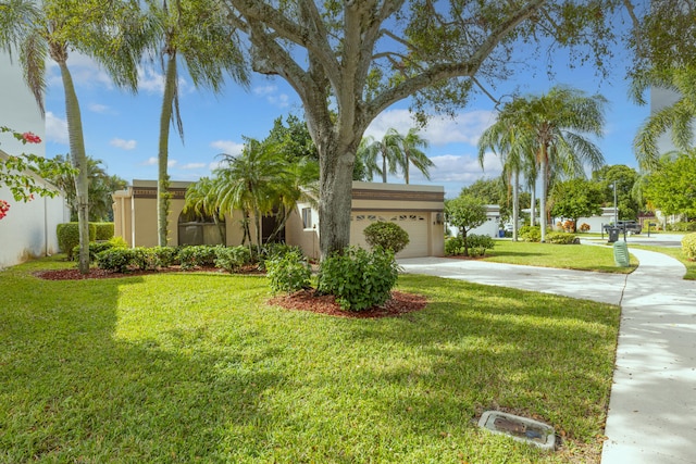 view of front of home featuring a front lawn and a garage