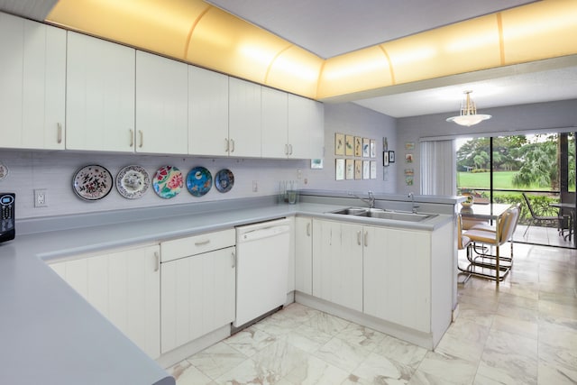 kitchen with dishwasher, white cabinets, decorative light fixtures, and sink