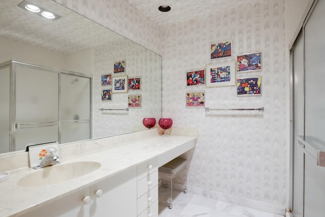 bathroom with vanity and a shower with shower door