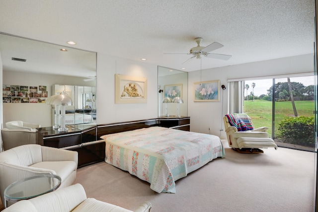 carpeted bedroom with ceiling fan, a textured ceiling, and access to outside