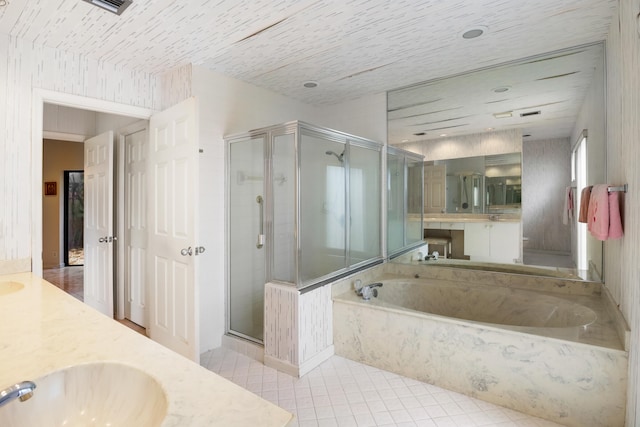 bathroom with plus walk in shower, vanity, and tile patterned floors