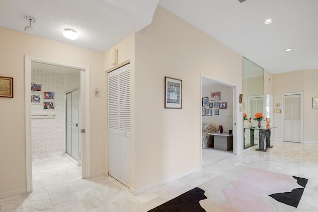 corridor with a textured ceiling