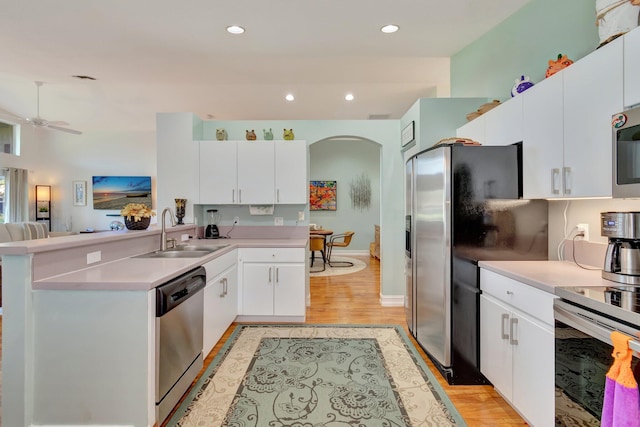 kitchen featuring light hardwood / wood-style flooring, stainless steel appliances, white cabinetry, and sink