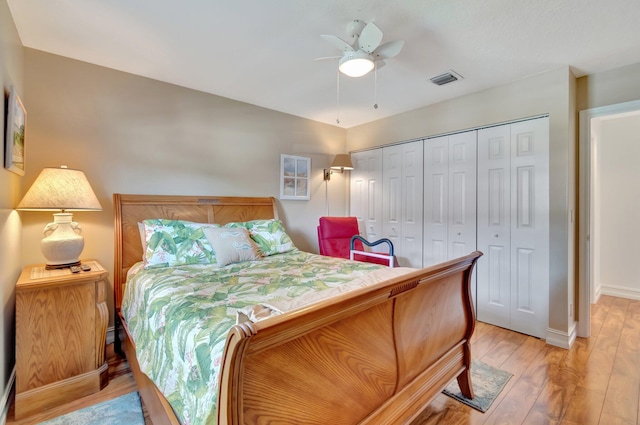 bedroom featuring ceiling fan, light wood-type flooring, and a closet