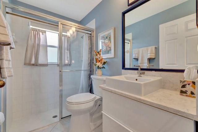 bathroom featuring vanity, toilet, and walk in shower