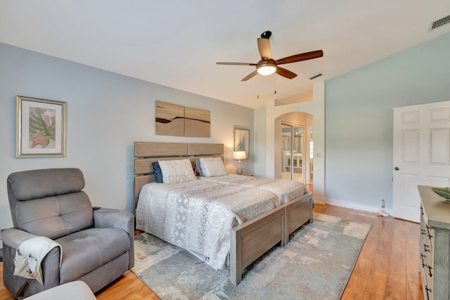 bedroom with ceiling fan, light hardwood / wood-style floors, and lofted ceiling