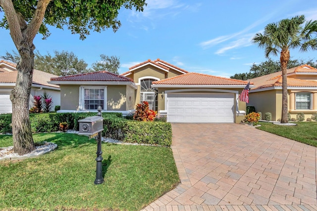 view of front of house featuring a front yard and a garage