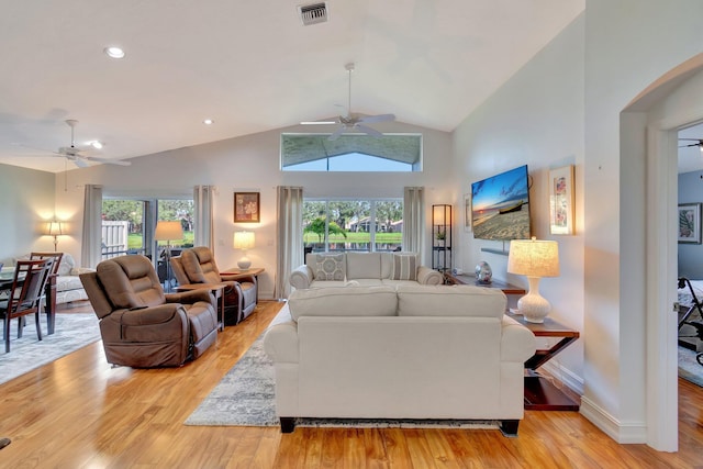 living room with ceiling fan, light hardwood / wood-style flooring, and lofted ceiling