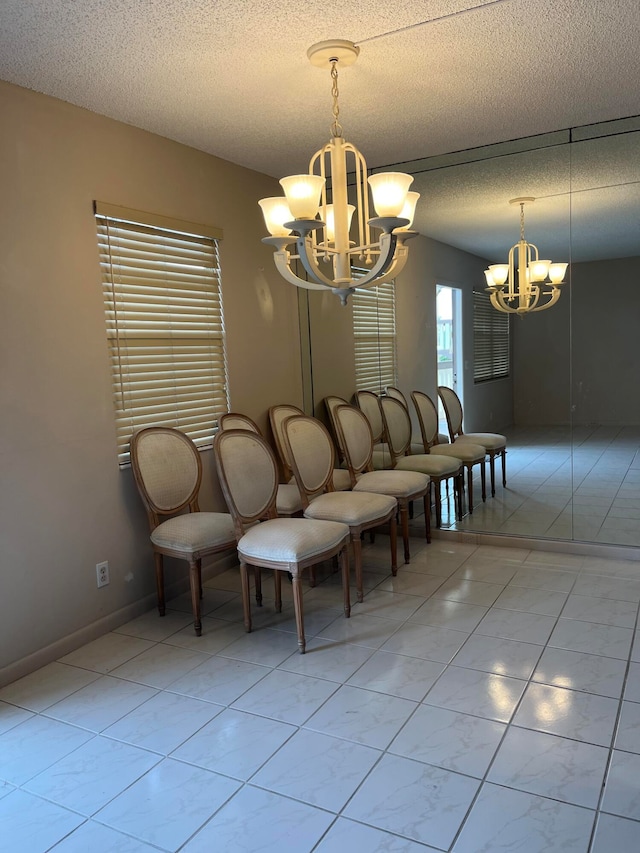 unfurnished dining area with a textured ceiling and a notable chandelier