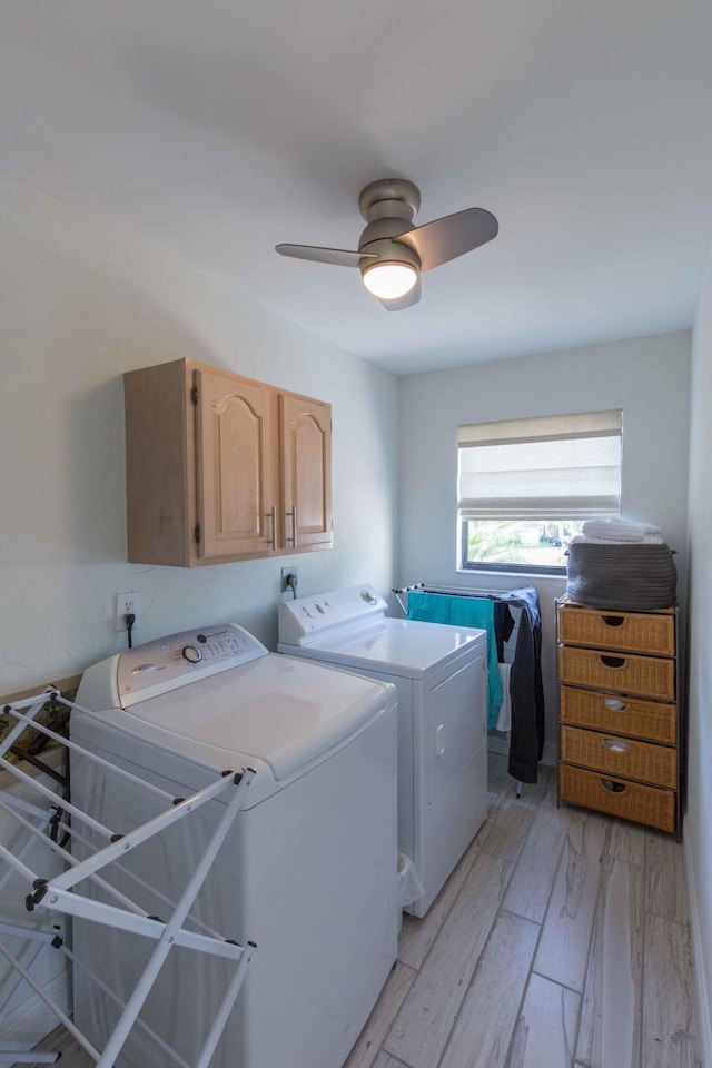 clothes washing area featuring ceiling fan, light hardwood / wood-style flooring, cabinets, and independent washer and dryer