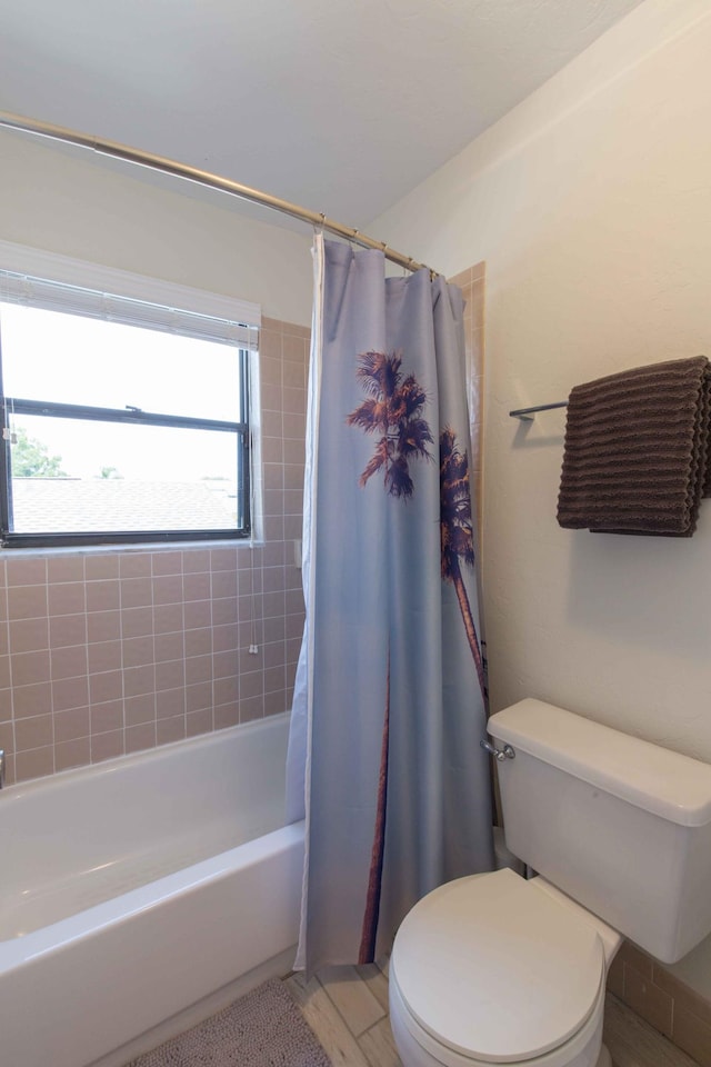 bathroom with toilet and shower / tub combo with curtain