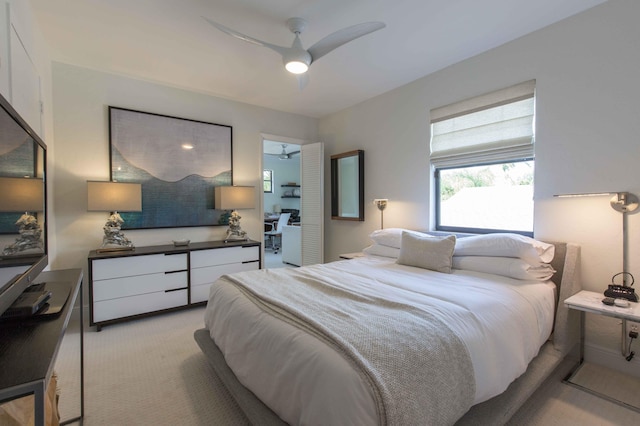 bedroom featuring light colored carpet and ceiling fan