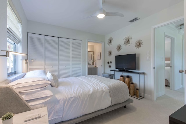 bedroom featuring ceiling fan, a closet, and light carpet