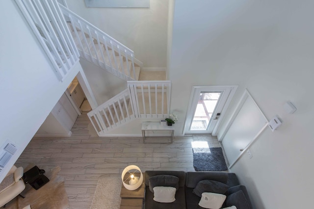 interior space featuring hardwood / wood-style floors and a towering ceiling