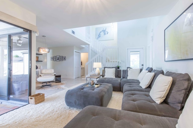 living room featuring hardwood / wood-style floors and ceiling fan