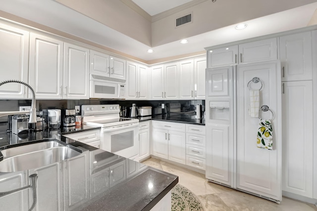 kitchen with white appliances, white cabinets, crown molding, sink, and light tile patterned floors