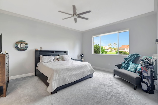 carpeted bedroom featuring ceiling fan and ornamental molding