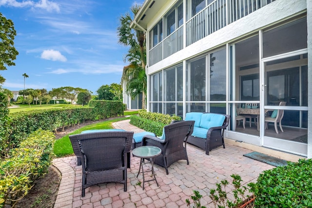 view of patio with a sunroom