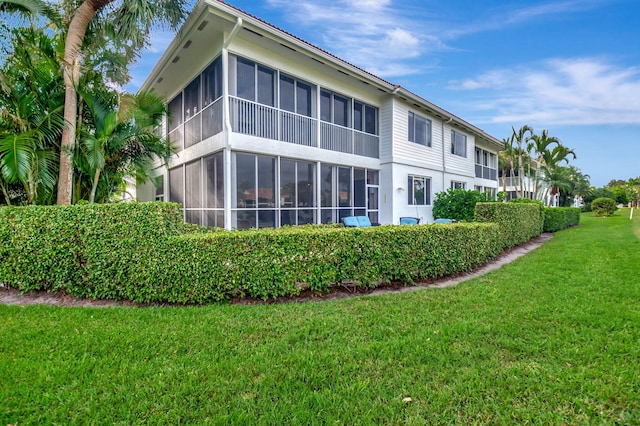 view of side of home with a lawn